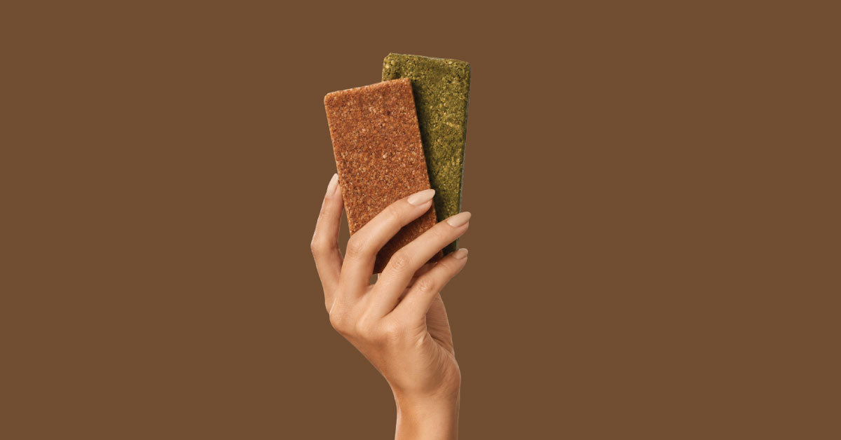 Assortment of COZY refrigerated date and oat snack bars in Warm Cinnamon and Salted Matcha flavors