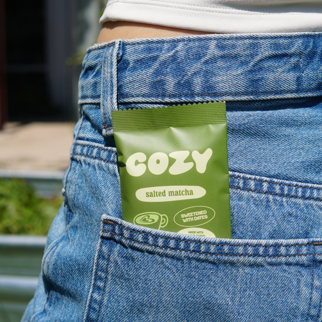 COZY Salted Matcha snack bar tucked into a pocket, ready to grab and go